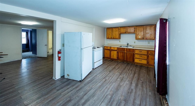670 S Main St, Saint Clair, MO 63077 - kitchen with white appliances, a sink, brown cabinetry, and dark wood-style flooring