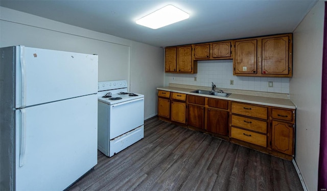 670 S Main St, Saint Clair, MO 63077 - kitchen featuring white appliances, a sink, brown cabinets, and dark wood finished floors