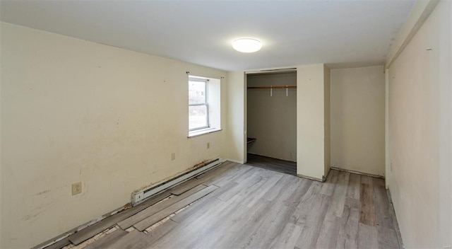 670 S Main St, Saint Clair, MO 63077 - unfurnished bedroom featuring a baseboard radiator, light wood-type flooring, and a closet
