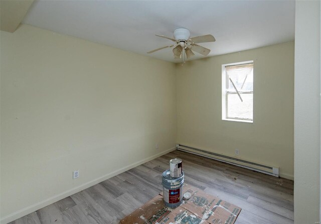 670 S Main St, Saint Clair, MO 63077 - spare room featuring a baseboard radiator, ceiling fan, wood finished floors, and baseboards