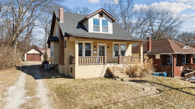 3142 Thelma Ave, Saint Louis, MO 63121 - bungalow featuring a porch, an outbuilding, a chimney, and roof with shingles