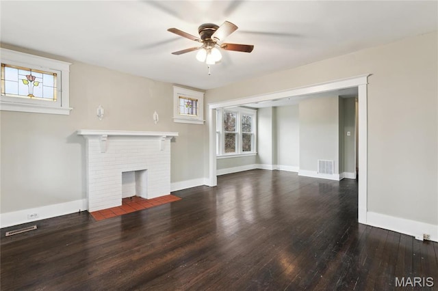 3142 Thelma Ave, Saint Louis, MO 63121 - unfurnished living room with healthy amount of natural light, ceiling fan, hardwood / wood-style flooring, and a brick fireplace