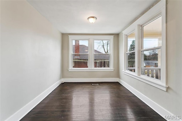 3142 Thelma Ave, Saint Louis, MO 63121 - spare room featuring baseboards and dark wood-style flooring
