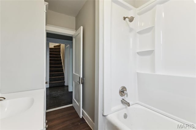 3142 Thelma Ave, Saint Louis, MO 63121 - bathroom with wood finished floors, baseboards, and shower / tub combination