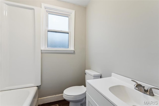 3142 Thelma Ave, Saint Louis, MO 63121 - full bathroom with toilet, vanity, a bathtub, and wood finished floors
