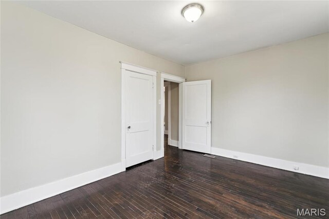 3142 Thelma Ave, Saint Louis, MO 63121 - unfurnished room featuring baseboards and dark wood-style flooring