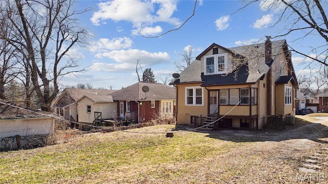 3142 Thelma Ave, Saint Louis, MO 63121 - rear view of house with stucco siding, a shingled roof, and a yard