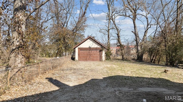 3142 Thelma Ave, Saint Louis, MO 63121 - view of yard featuring an outbuilding, dirt driveway, and a detached garage