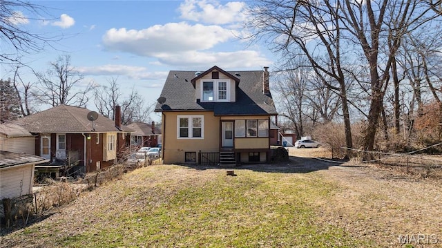 3142 Thelma Ave, Saint Louis, MO 63121 - view of front facade with a chimney, a front lawn, and a shingled roof