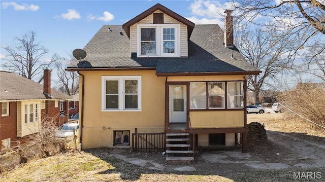 3142 Thelma Ave, Saint Louis, MO 63121 - rear view of property featuring a chimney, roof with shingles, and stucco siding
