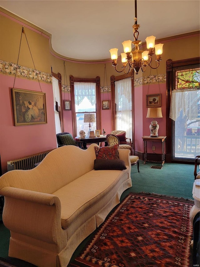 living area with a chandelier, carpet flooring, and ornamental molding