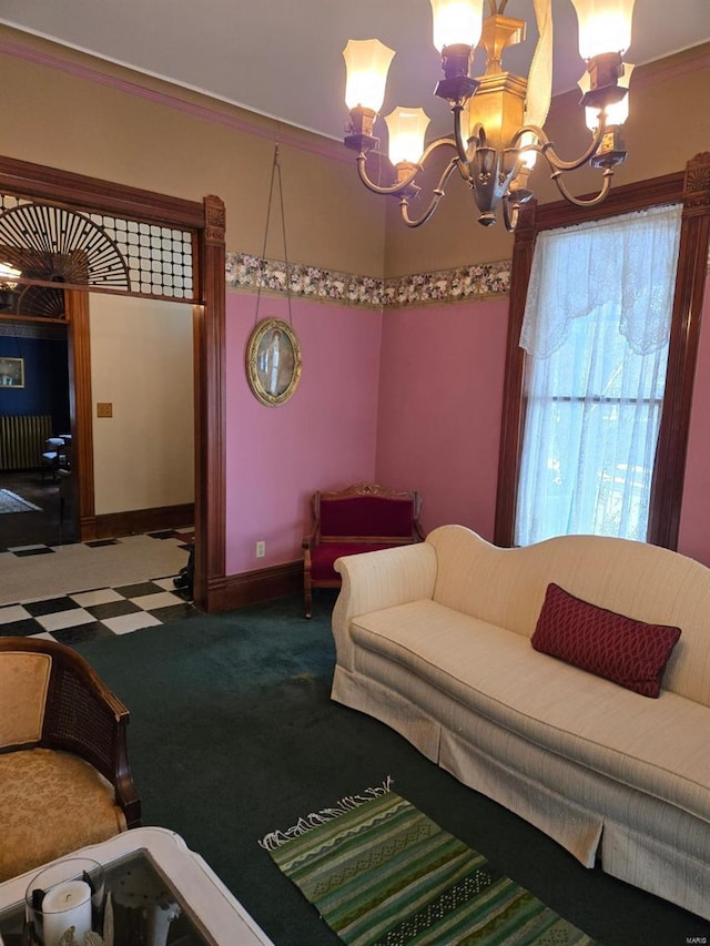 carpeted living room featuring a chandelier, crown molding, and baseboards