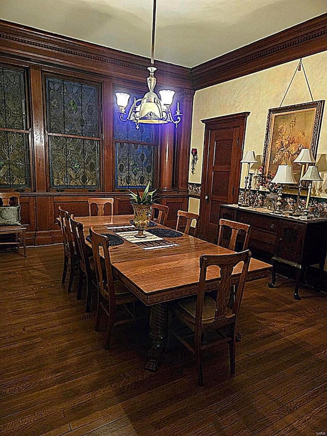dining room featuring a chandelier, dark wood-type flooring, and ornamental molding