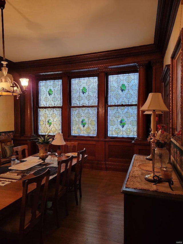 dining space featuring crown molding, a chandelier, and hardwood / wood-style floors