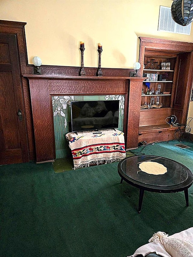 detailed view of carpet and a glass covered fireplace