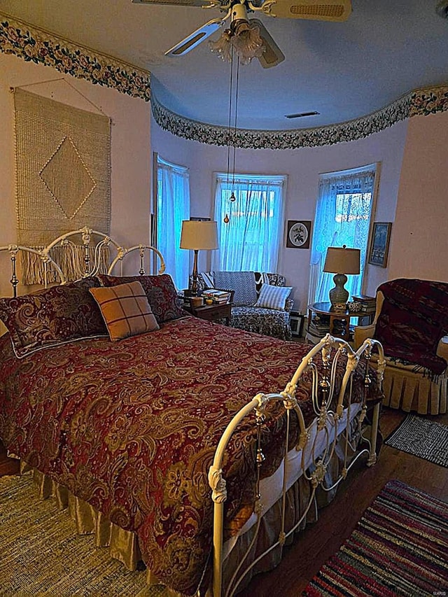 bedroom with wood finished floors and a ceiling fan