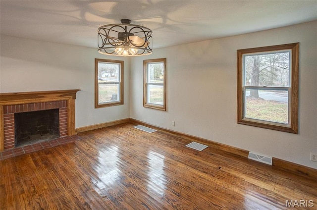 134 N 82nd St, Belleville, IL 62223 - unfurnished living room featuring a chandelier, wood finished floors, baseboards, and a fireplace