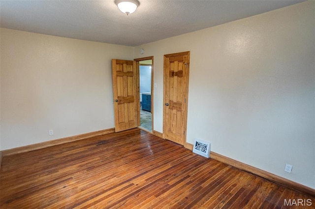 134 N 82nd St, Belleville, IL 62223 - empty room featuring dark wood-type flooring and baseboards