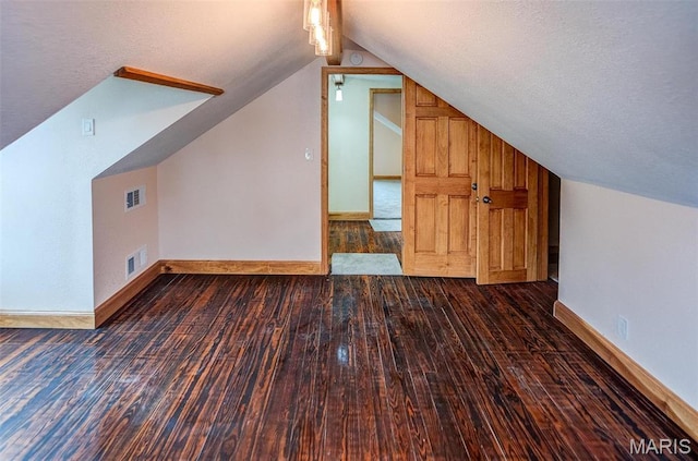 134 N 82nd St, Belleville, IL 62223 - additional living space featuring lofted ceiling, wood finished floors, baseboards, and a textured ceiling