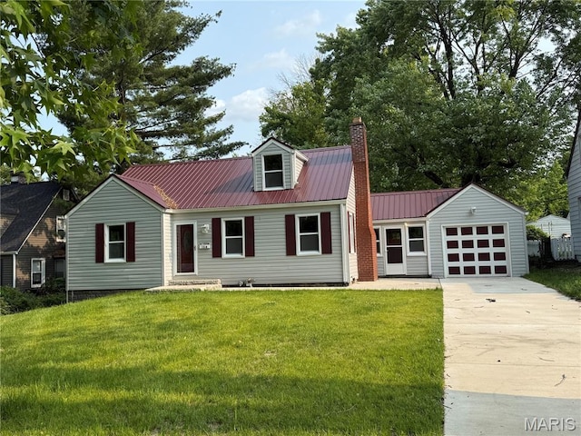134 N 82nd St, Belleville, IL 62223 - view of front of home with an attached garage, concrete driveway, a front yard, metal roof, and a chimney