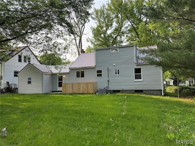 134 N 82nd St, Belleville, IL 62223 - rear view of house with a lawn, metal roof, and central AC unit