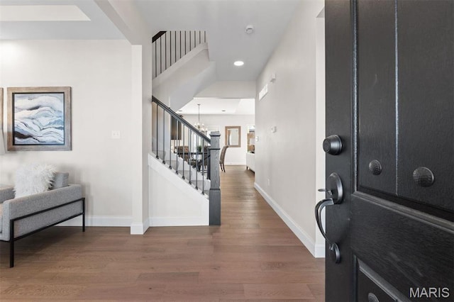entryway with stairway, baseboards, a chandelier, wood finished floors, and recessed lighting