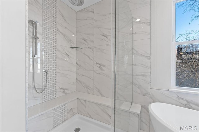 bathroom with a stall shower, a soaking tub, and tile walls