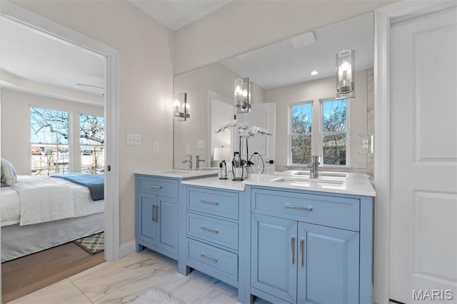 full bathroom featuring double vanity, plenty of natural light, ensuite bathroom, and marble finish flooring