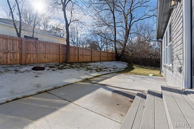 fenced backyard with a patio area