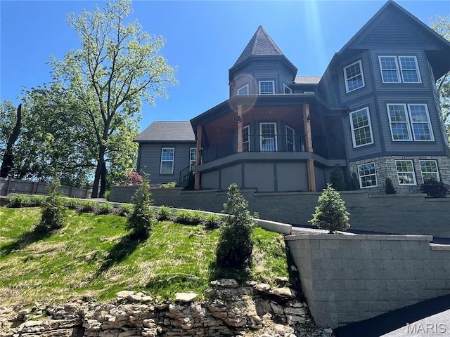 view of front of home with a balcony