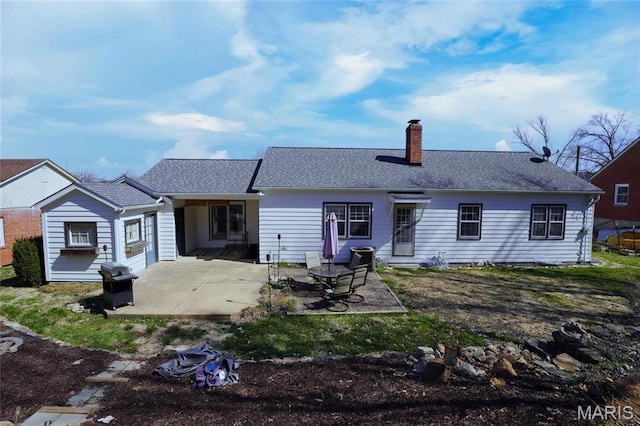 1014 Jefferson St, Hermann, MO 65041 - rear view of property featuring a chimney, a patio, and roof with shingles