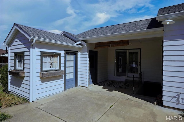 1014 Jefferson St, Hermann, MO 65041 - view of exterior entry with roof with shingles and a patio