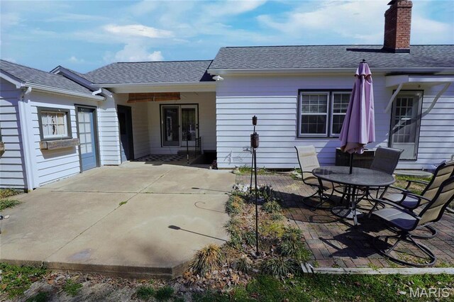 1014 Jefferson St, Hermann, MO 65041 - rear view of house with a patio area, a chimney, and a shingled roof