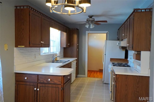 1014 Jefferson St, Hermann, MO 65041 - kitchen with a chandelier, dishwasher, gas stove, ceiling fan, and tasteful backsplash