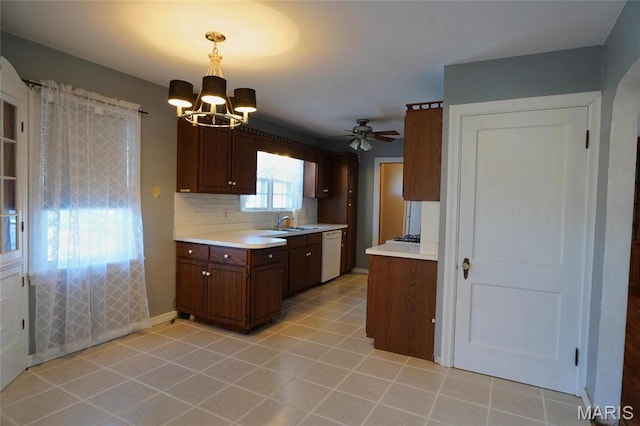 1014 Jefferson St, Hermann, MO 65041 - kitchen with white dishwasher, a chandelier, light countertops, and tasteful backsplash