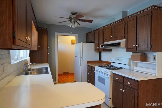 1014 Jefferson St, Hermann, MO 65041 - kitchen featuring white appliances, under cabinet range hood, a ceiling fan, and decorative backsplash