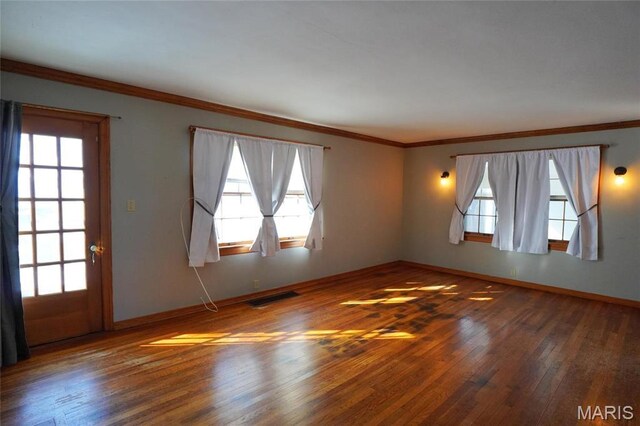 1014 Jefferson St, Hermann, MO 65041 - empty room featuring hardwood / wood-style flooring, healthy amount of natural light, and ornamental molding