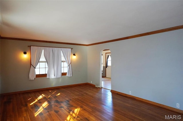 1014 Jefferson St, Hermann, MO 65041 - empty room featuring arched walkways, wood finished floors, and crown molding