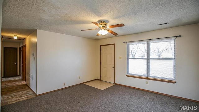 13060 Kimberly Ln, De Soto, MO 63020 - carpeted spare room featuring a textured ceiling, ceiling fan, and baseboards