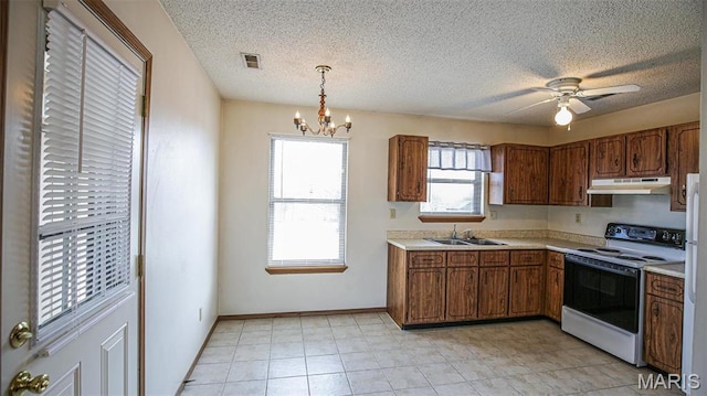 13060 Kimberly Ln, De Soto, MO 63020 - kitchen featuring range with electric stovetop, under cabinet range hood, a sink, brown cabinetry, and a textured ceiling