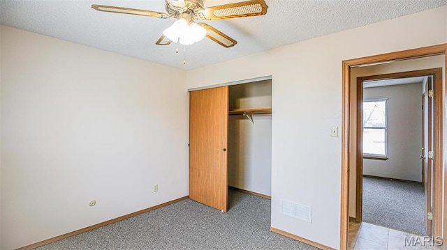 13060 Kimberly Ln, De Soto, MO 63020 - unfurnished bedroom featuring a closet, baseboards, light colored carpet, ceiling fan, and a textured ceiling