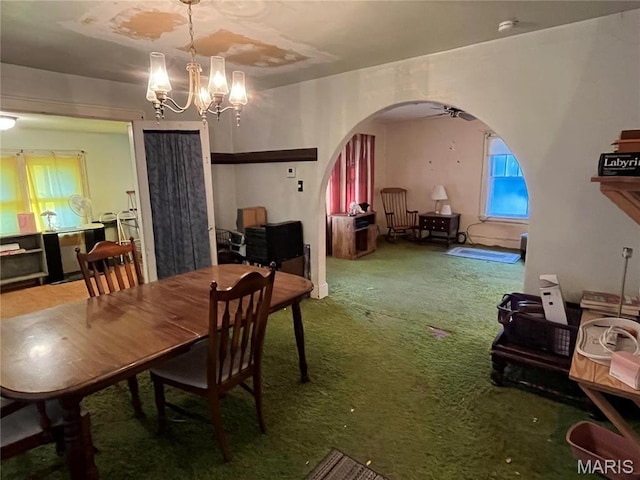 3620 Thomas Ave, Alton, IL 62002 - carpeted dining room with arched walkways, a chandelier, and a ceiling fan