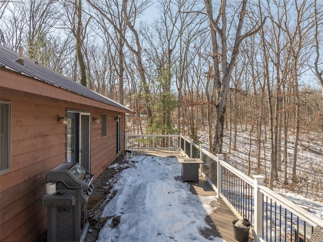 snow covered deck featuring a grill