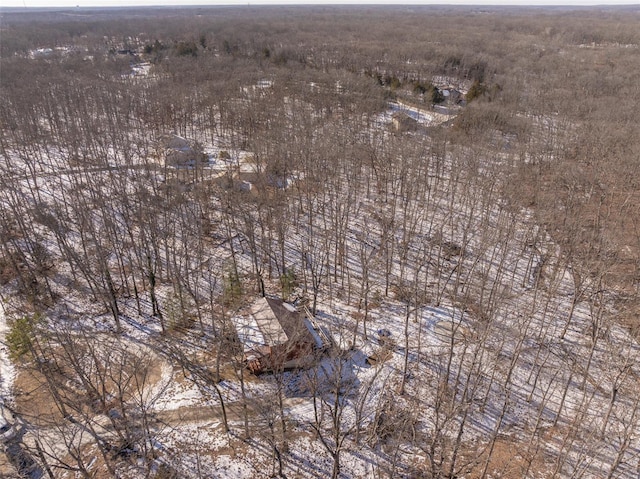 aerial overview of property's location with a heavily wooded area