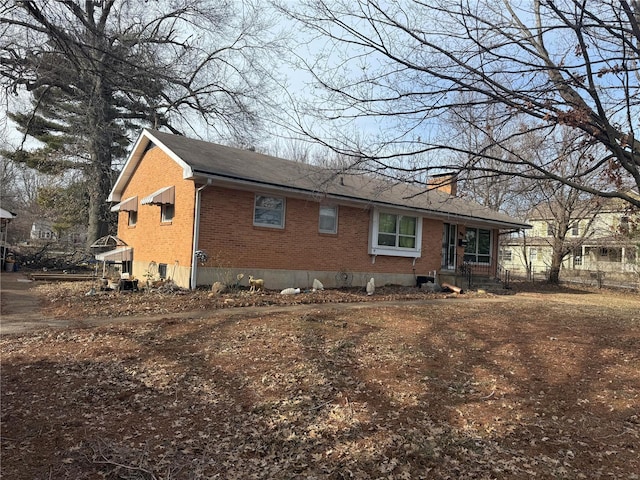 599 N Washington St, Farmington, MO 63640 - view of side of home featuring brick siding, a chimney, and a shingled roof