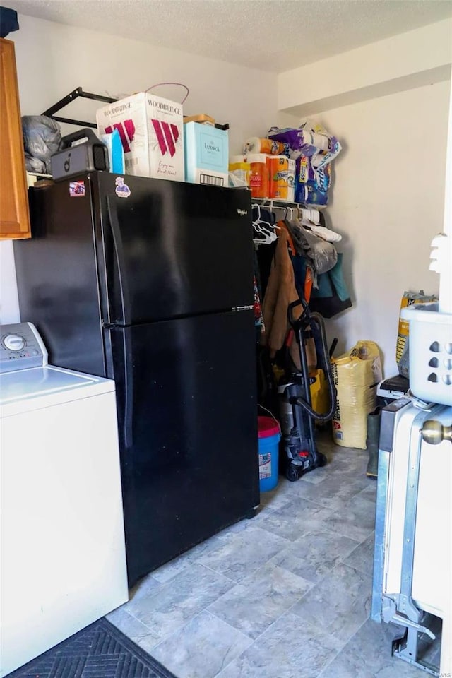 interior space with washer / dryer and freestanding refrigerator