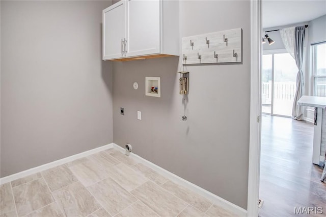 laundry area with gas dryer hookup, washer hookup, cabinet space, electric dryer hookup, and baseboards