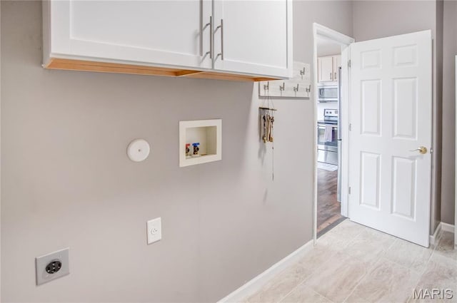 laundry room featuring hookup for an electric dryer, cabinet space, hookup for a washing machine, and baseboards