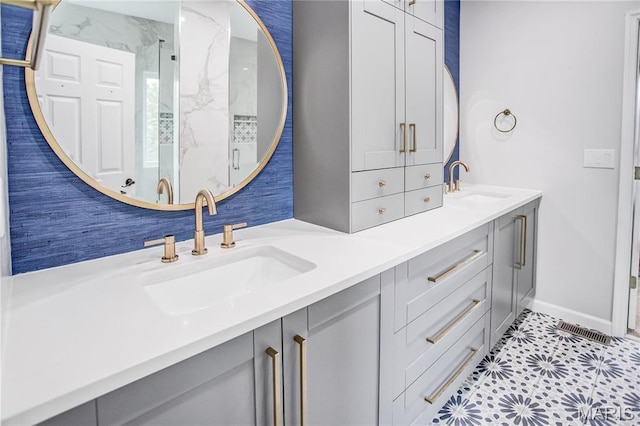full bathroom featuring double vanity and baseboards