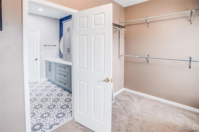spacious closet featuring a sink